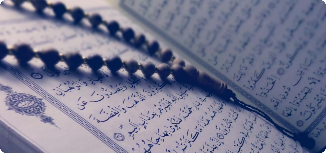 Prayer beads on an open Quran page