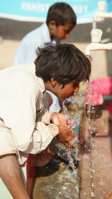 Boy drinking from cupped hands